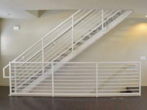 White metal staircase with beige walls.